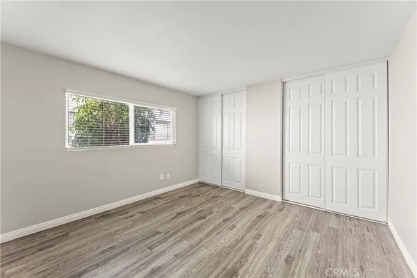 a view of wooden floor and windows in a room