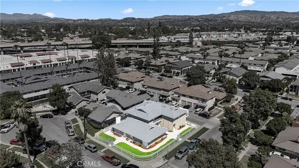 an aerial view of a houses with yard