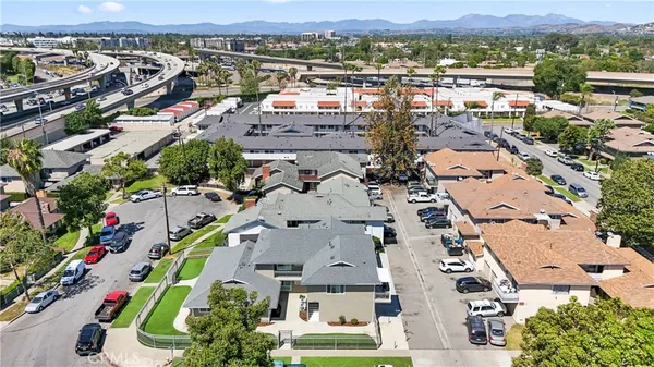 an aerial view of a swimming pool patio and mountain view in back