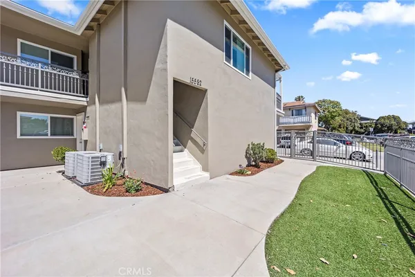 a view of a house with backyard and sitting area