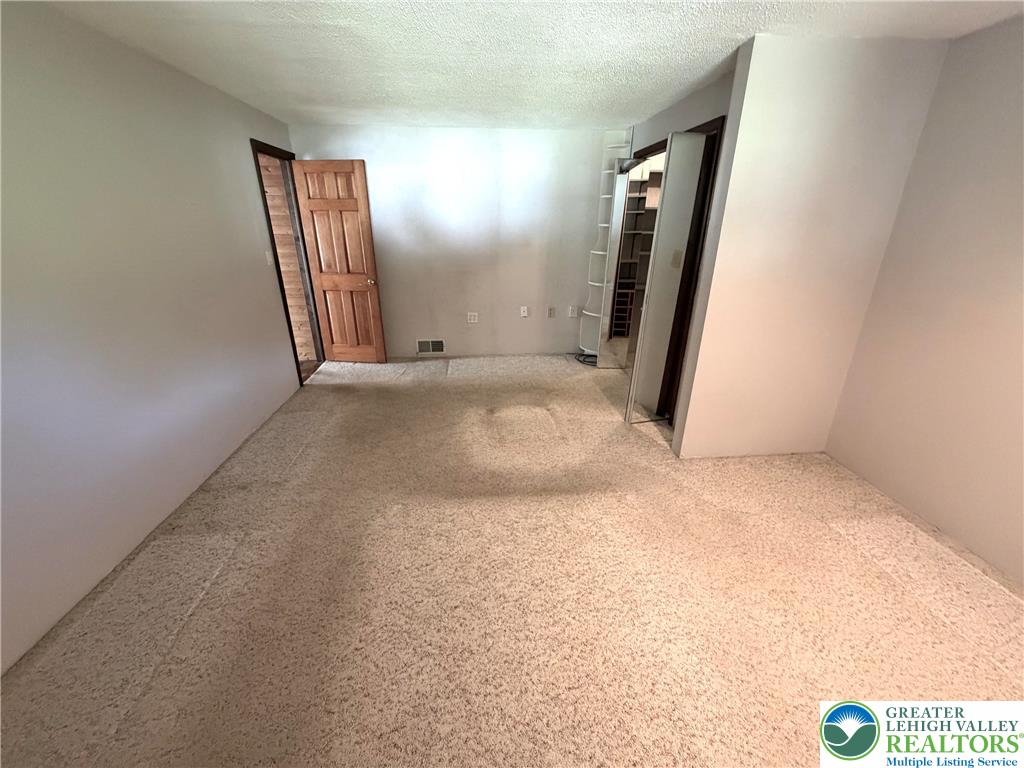 2741 Limestone Street Coplay, PA 18037 - Photo 25 of 35 an empty room with staircase and mirror