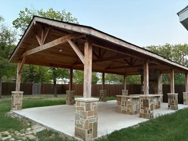 a view of a chair and table in patio with a small yard