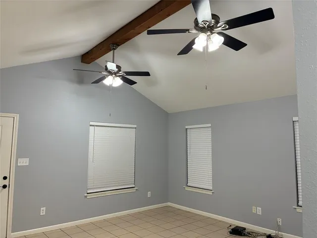 a view of a livingroom with a ceiling fan and window