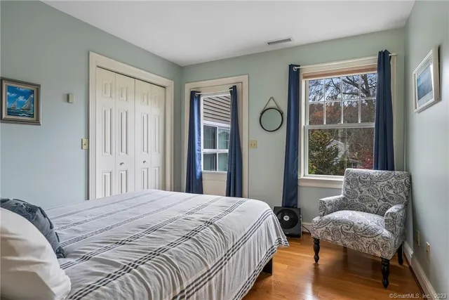 a bathroom with a granite countertop sink mirror double vanity and bathtub