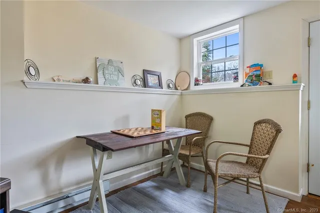 a living room with furniture a rug and a chandelier
