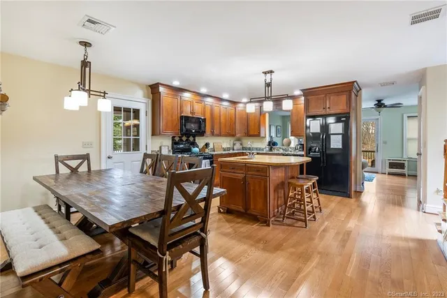 a kitchen with granite countertop a stove a sink and a wooden cabinets