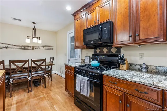 a kitchen with granite countertop a sink and cabinets