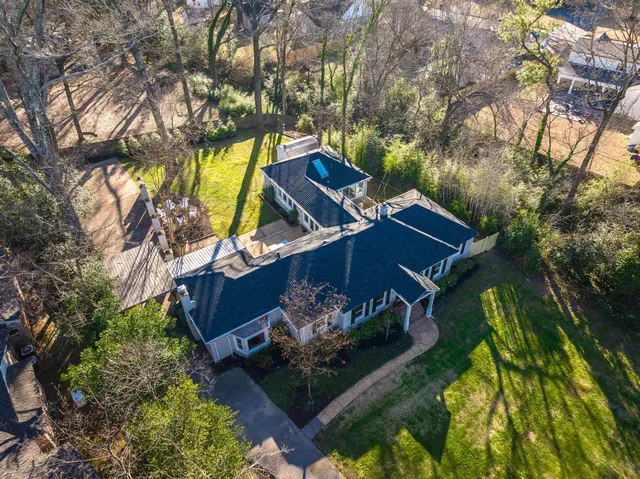 an aerial view of a house with a yard basket ball court and outdoor seating