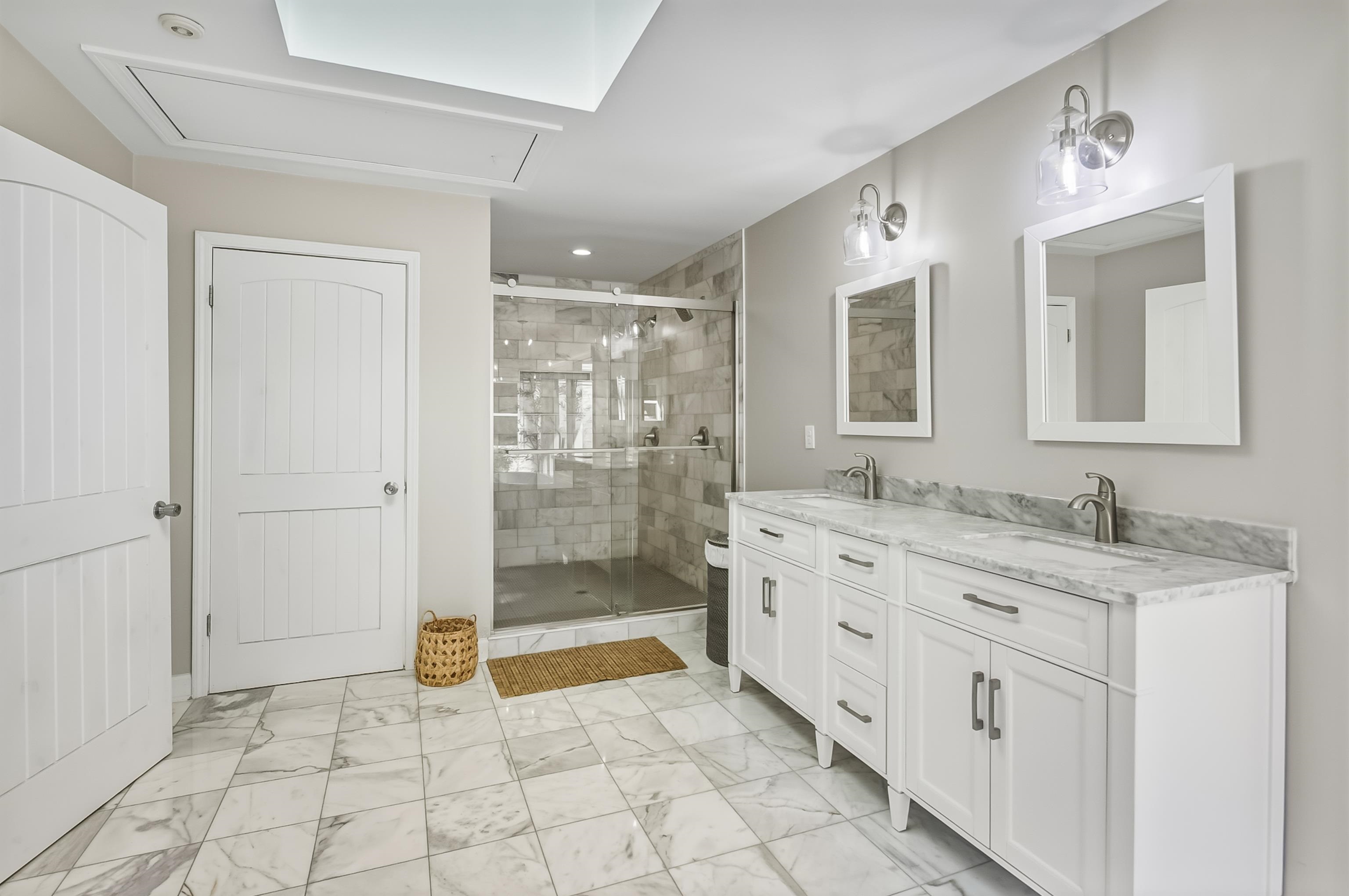 5155 Shady Grove Road Memphis, TN 38117 - Photo 24 of 40 Full bathroom with double vanity, light marble finish flooring, a shower stall, and recessed lighting