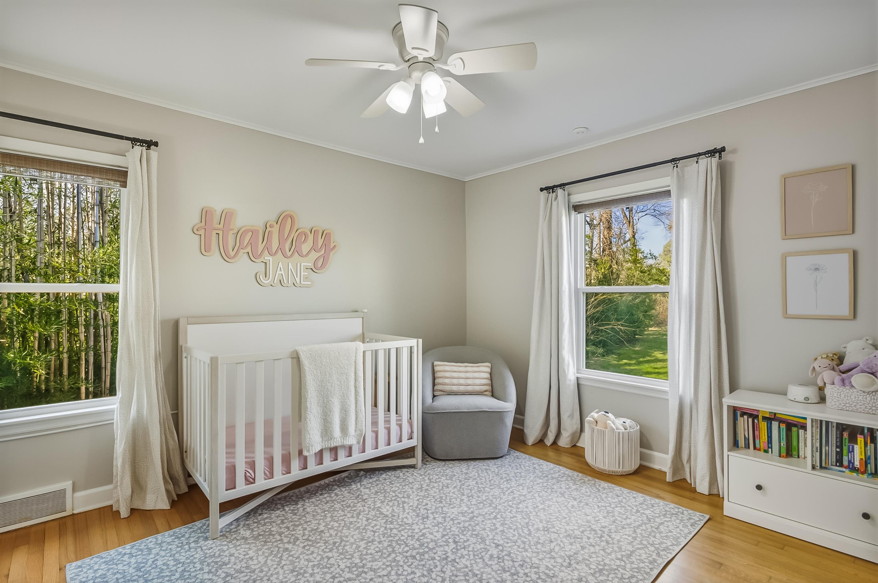 5155 Shady Grove Road Memphis, TN 38117 - Photo 30 of 40 Bedroom with a crib, light wood finished floors, ceiling fan, multiple windows, and ornamental molding