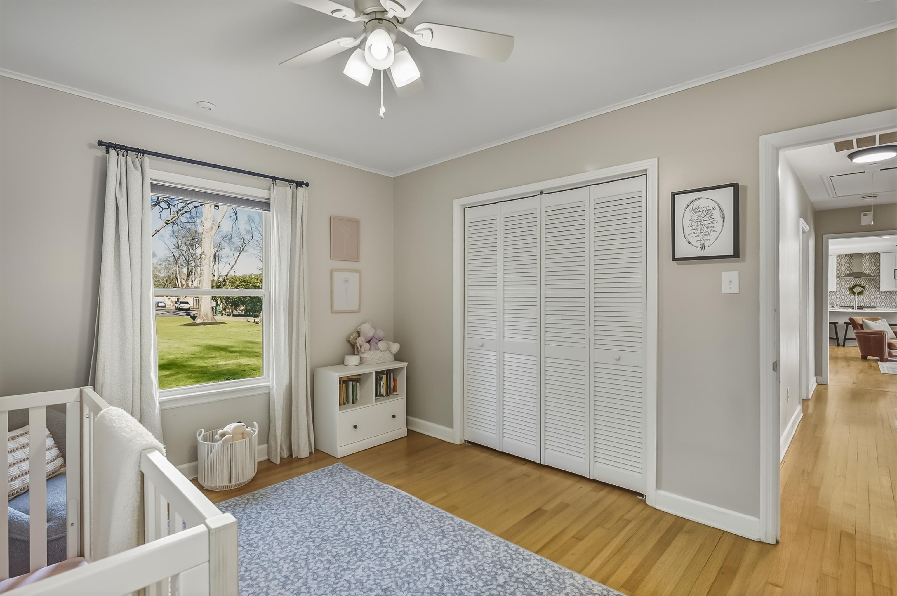 5155 Shady Grove Road Memphis, TN 38117 - Photo 31 of 40 Bedroom with light wood-style floors, a crib, ornamental molding, a closet, and ceiling fan