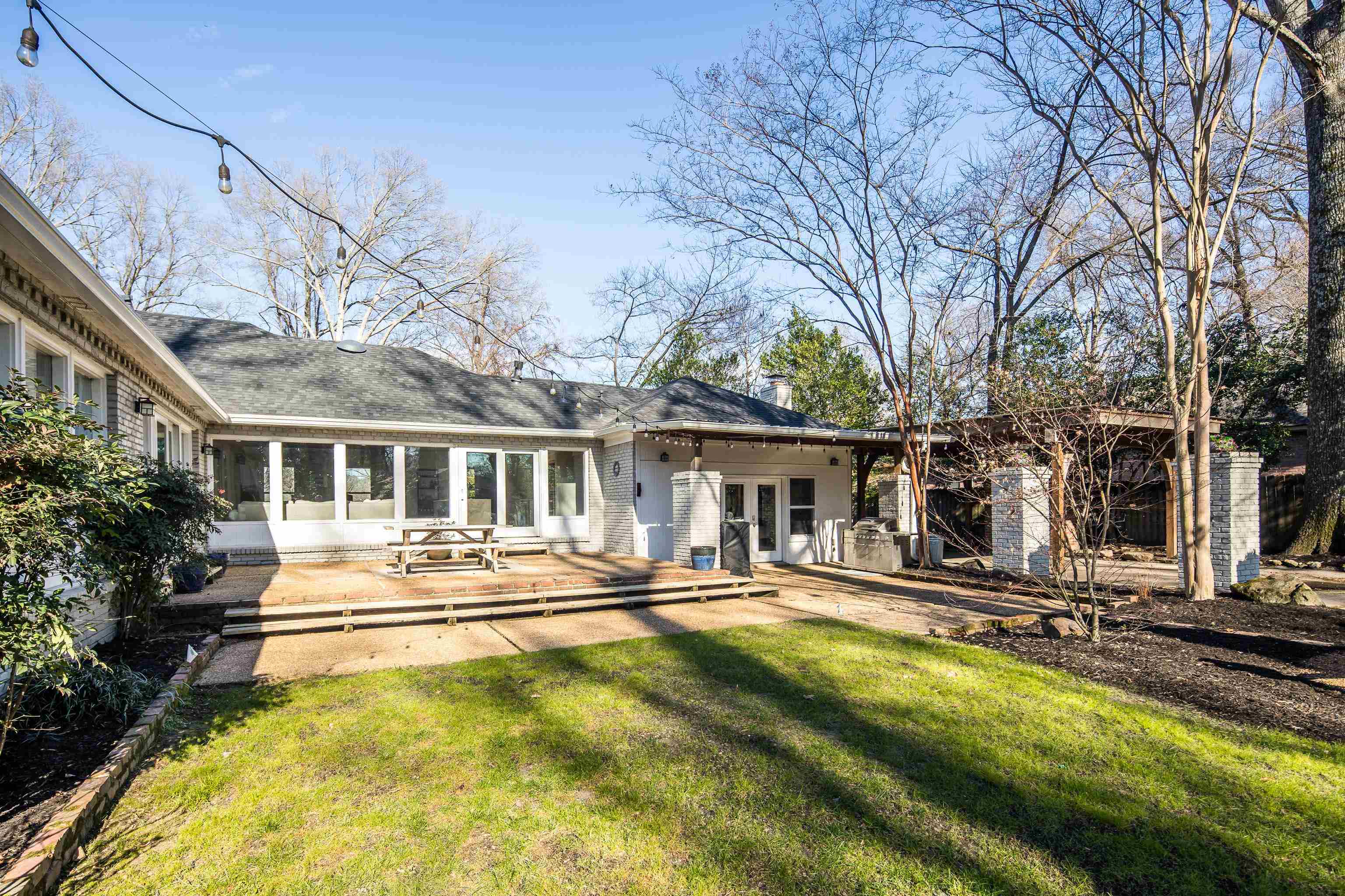 5155 Shady Grove Road Memphis, TN 38117 - Photo 36 of 40 Back of property featuring a patio area, a lawn, a sunroom, french doors, and brick siding