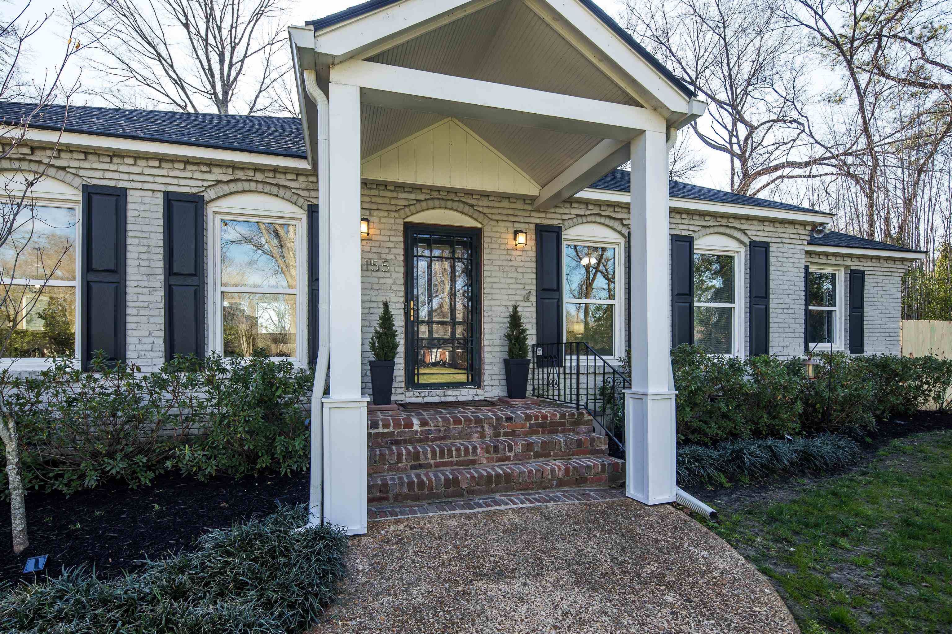 5155 Shady Grove Road Memphis, TN 38117 - Photo 5 of 40 Entrance to property featuring brick siding, a porch, and a shingled roof
