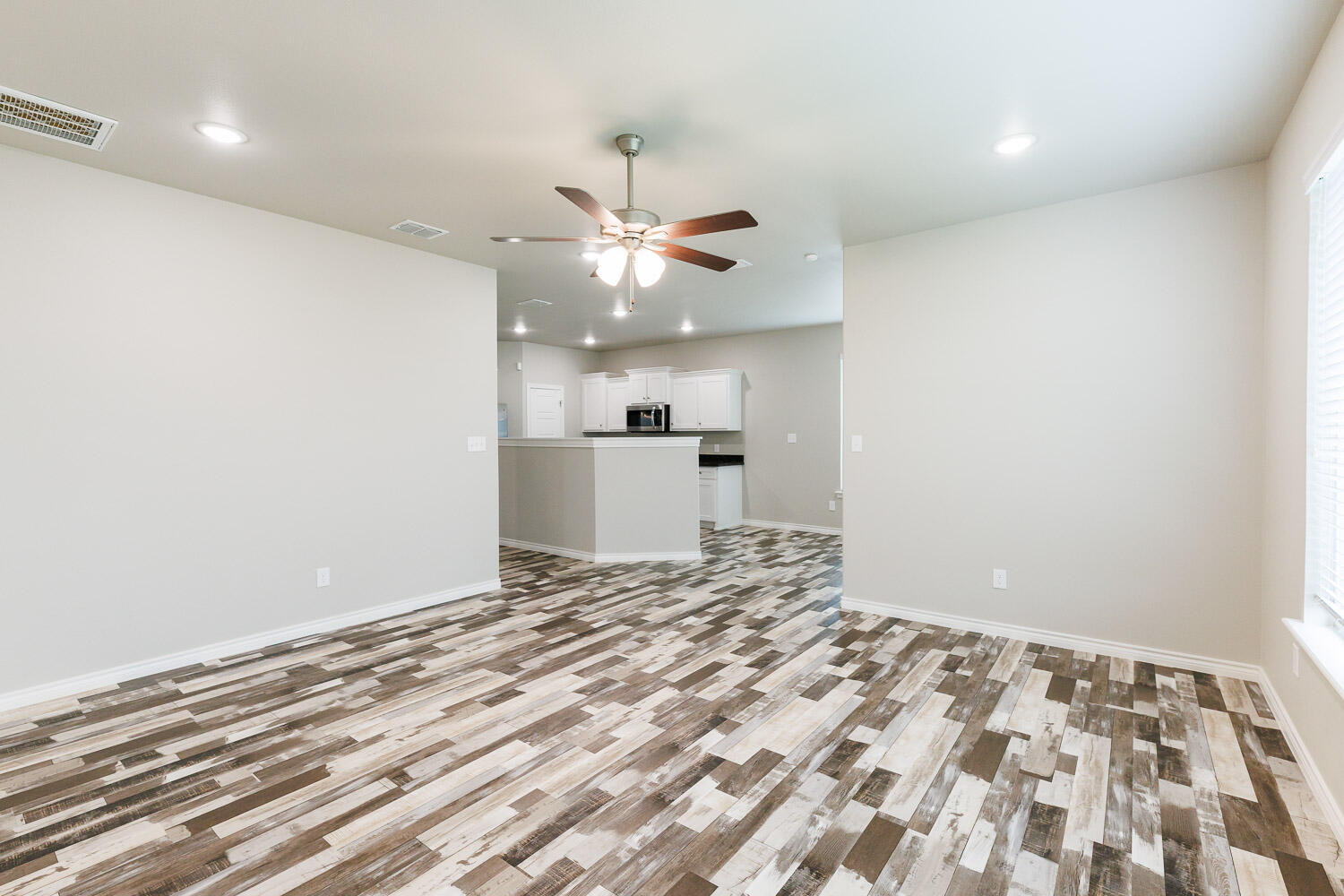 6956 12th Street Lubbock, TX 79416 - Photo 19 of 43 a view of a kitchen with a sink and a refrigerator