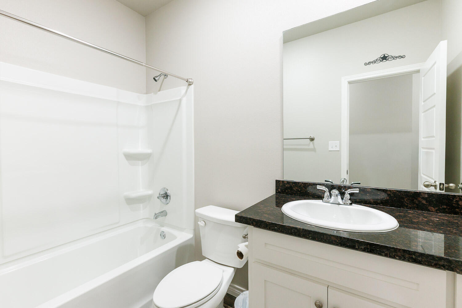6956 12th Street Lubbock, TX 79416 - Photo 29 of 43 a bathroom with a granite countertop sink toilet and shower