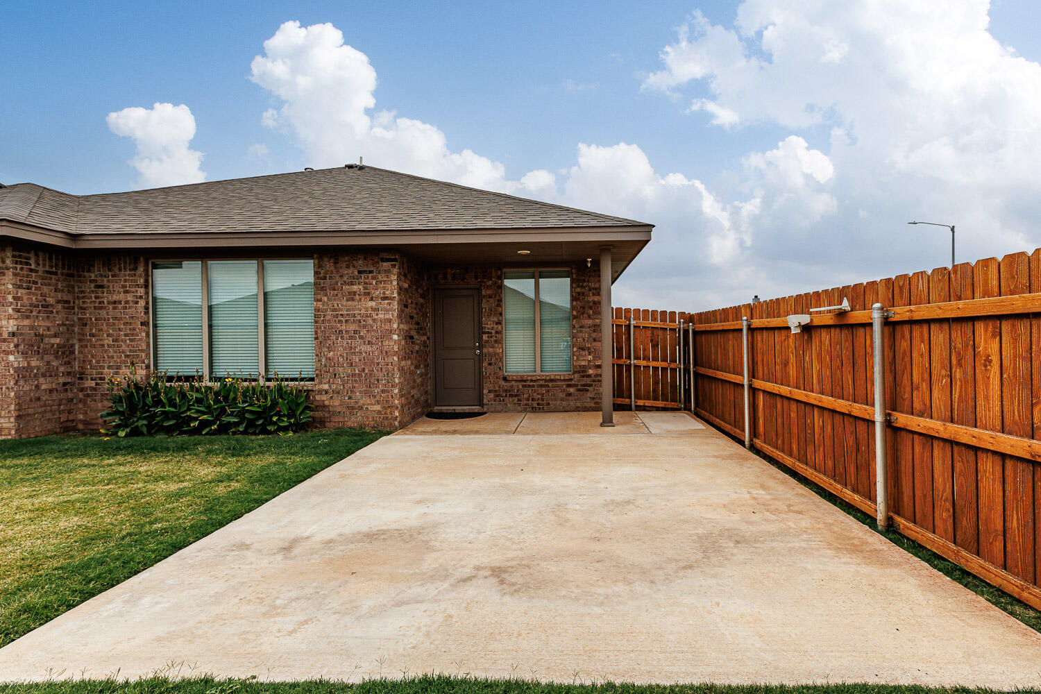 6956 12th Street Lubbock, TX 79416 - Photo 35 of 43 a front view of a house with a garden