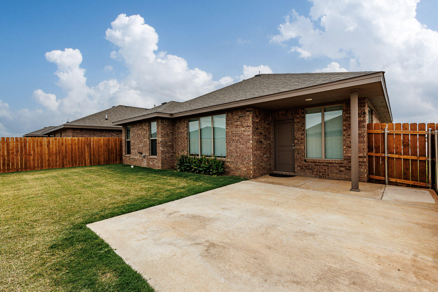 6956 12th Street Lubbock, TX 79416 - Photo 36 of 43 a front view of a house with garden