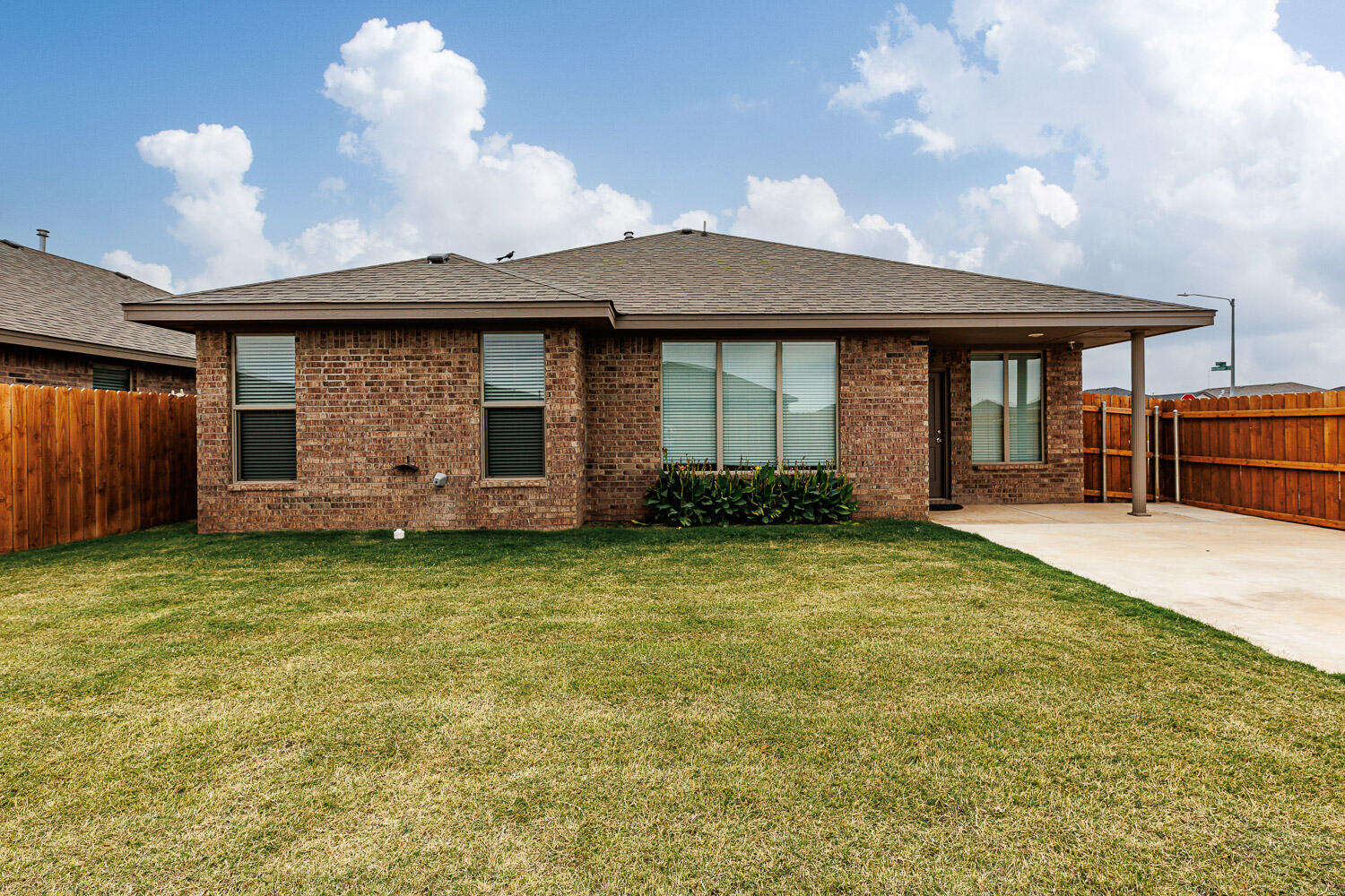 6956 12th Street Lubbock, TX 79416 - Photo 37 of 43 a front view of a house with garden