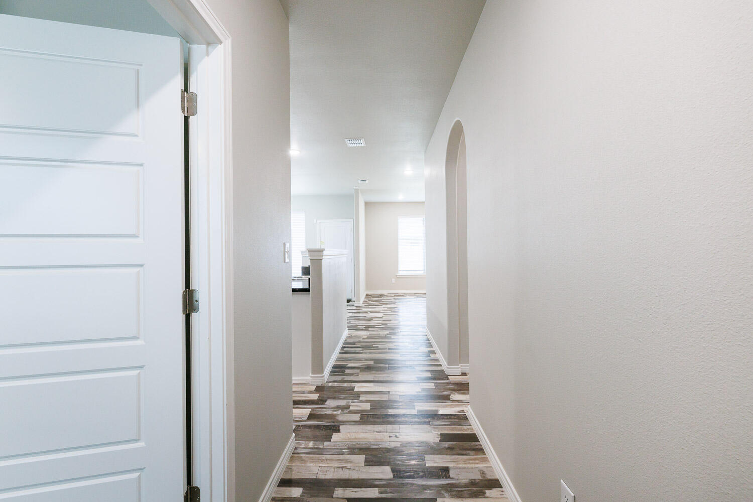 6956 12th Street Lubbock, TX 79416 - Photo 4 of 43 a view of a hallway with wooden floor and entryway