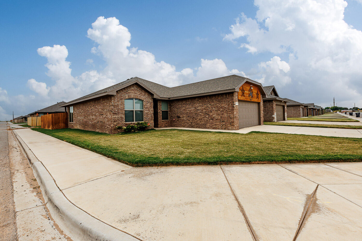 6956 12th Street Lubbock, TX 79416 - Photo 42 of 43 a front view of a house with a yard