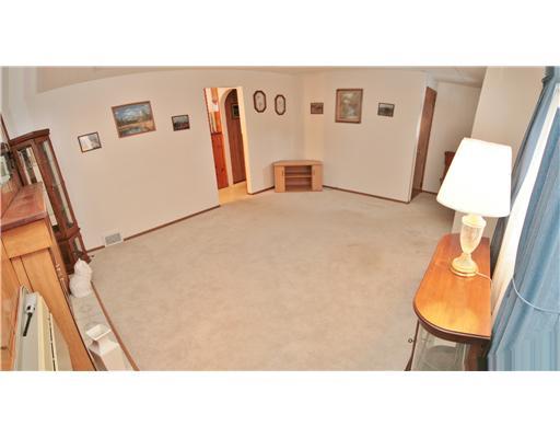 Living Room. View of Living Room from Fireplace looking toward Kitchen on your left and Entry to your right.