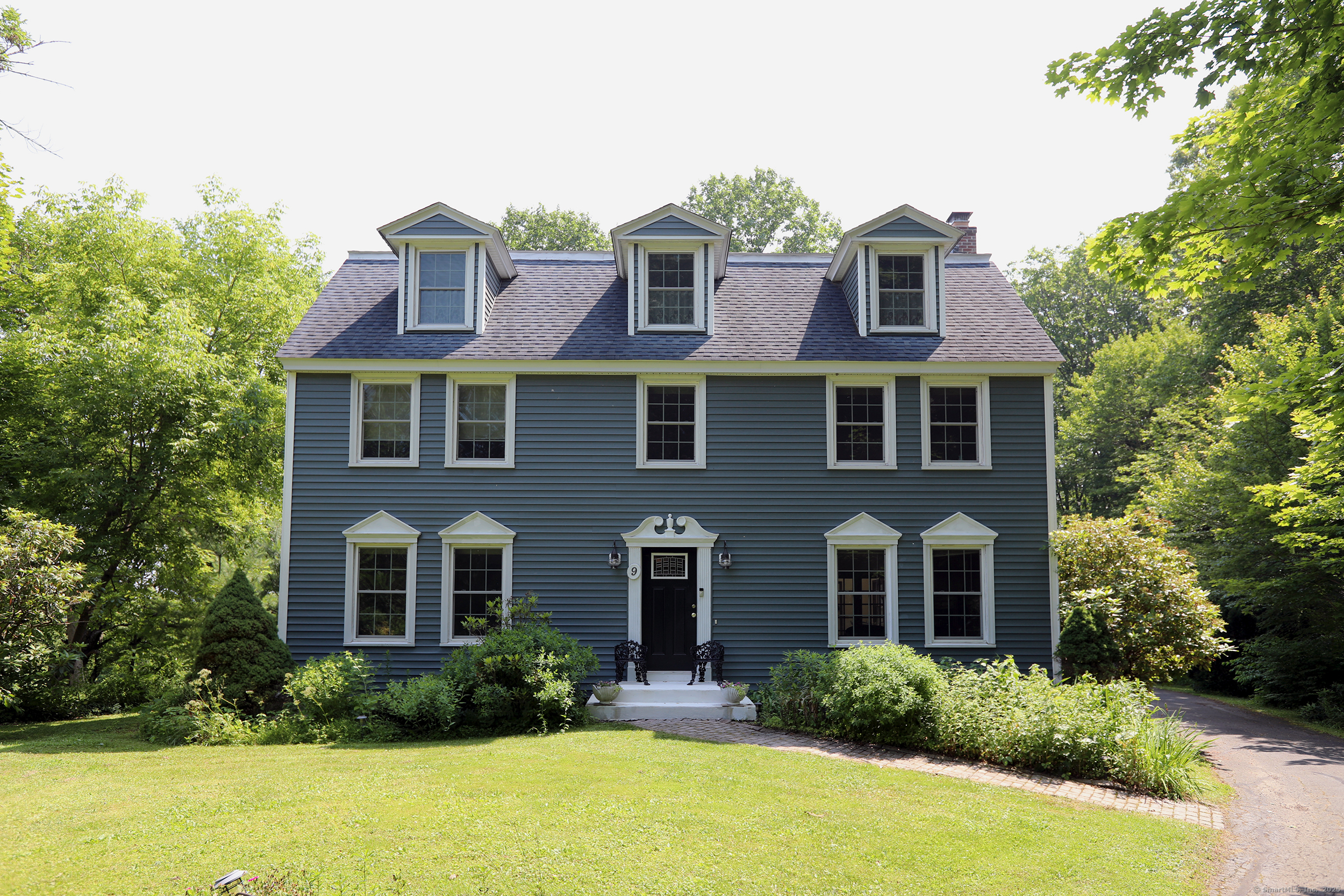 a front view of a house with swimming pool and glass windows