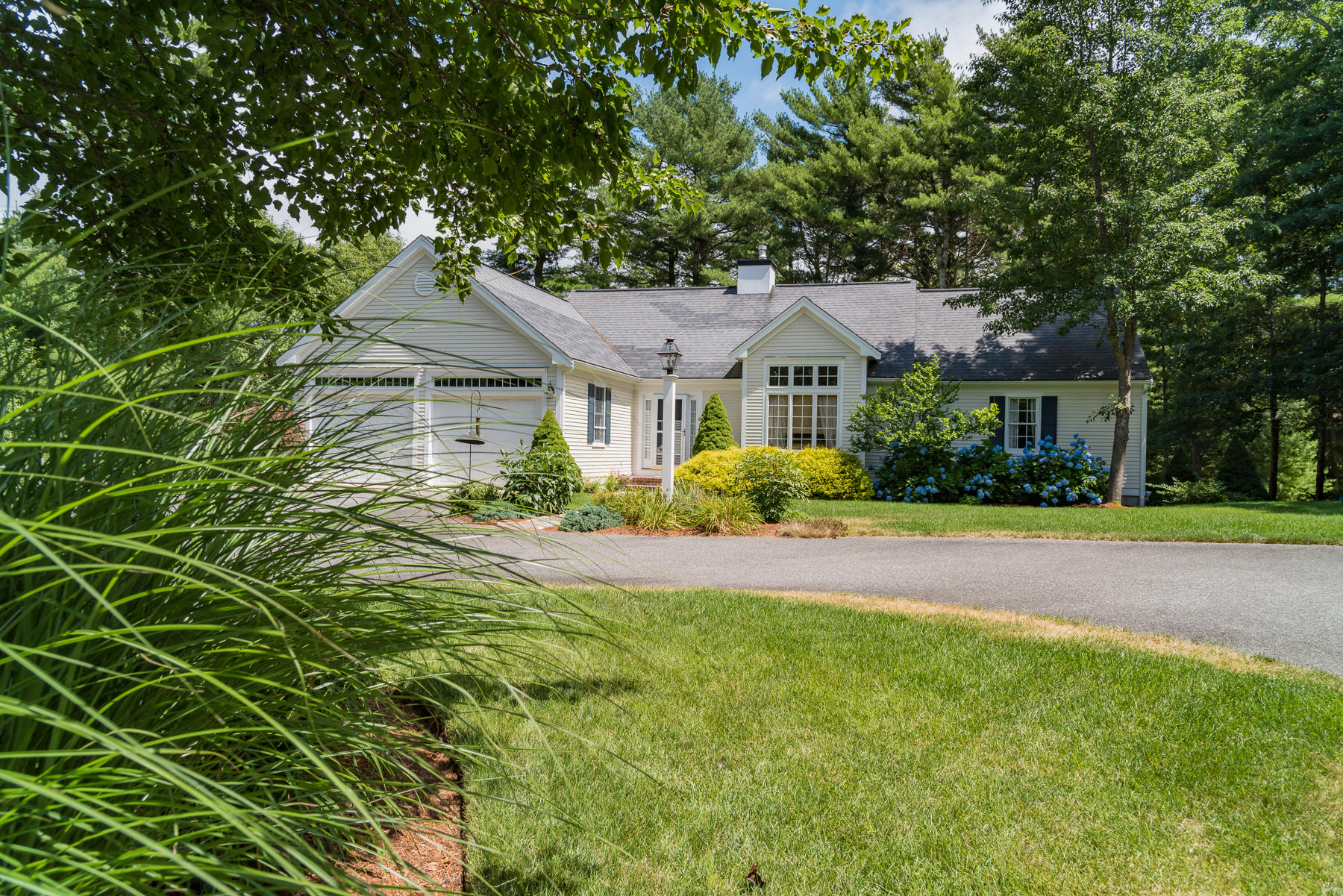 a front view of a house with a garden