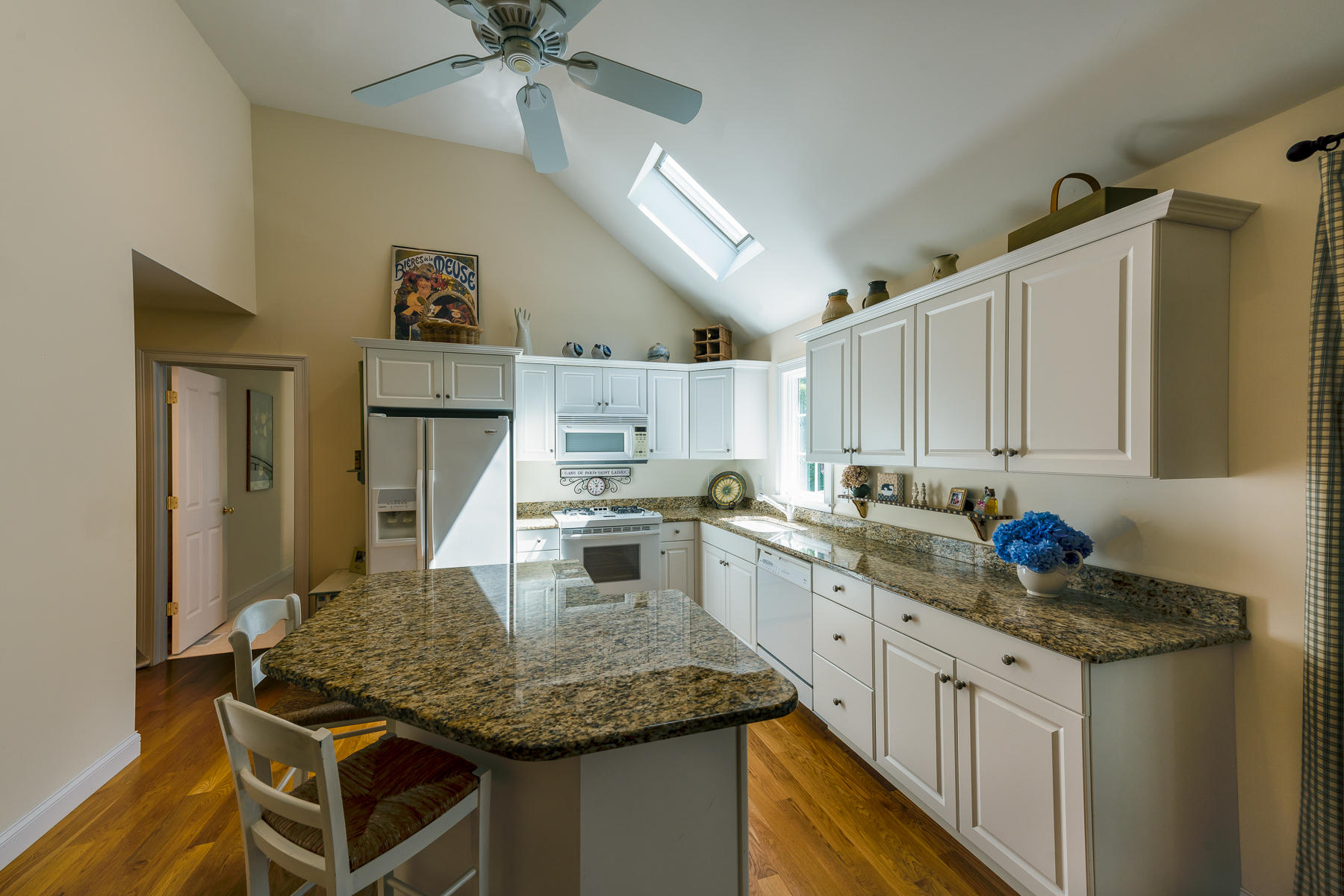 62 Sea Robin Road Osterville, MA 02655 - Photo 5 of 30 a kitchen with stainless steel appliances granite countertop a sink dishwasher and cabinets with wooden floor