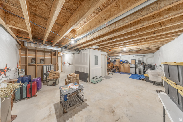 4765 Breezy Patch Road Eagle Mountain, UT 84005 - Photo 24 of 25 Unfinished basement with exposed ceiling joists, concrete flooring, framed wall sections, and overhead lighting
