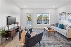 635 Main Street, Unit 211 Wilmington, MA 01887 - Photo 2 of 18 a living room with furniture and a flat screen tv