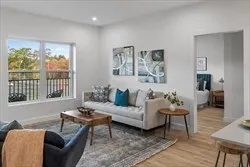 a living room with furniture and a large window