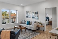 635 Main Street, Unit 211 Wilmington, MA 01887 - Photo 4 of 18 a living room with furniture and a large window