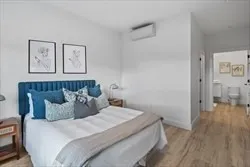 a bedroom with bed and painting on the wall