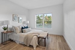 635 Main Street, Unit 211 Wilmington, MA 01887 - Photo 8 of 18 a bed sitting in a bedroom next to a window