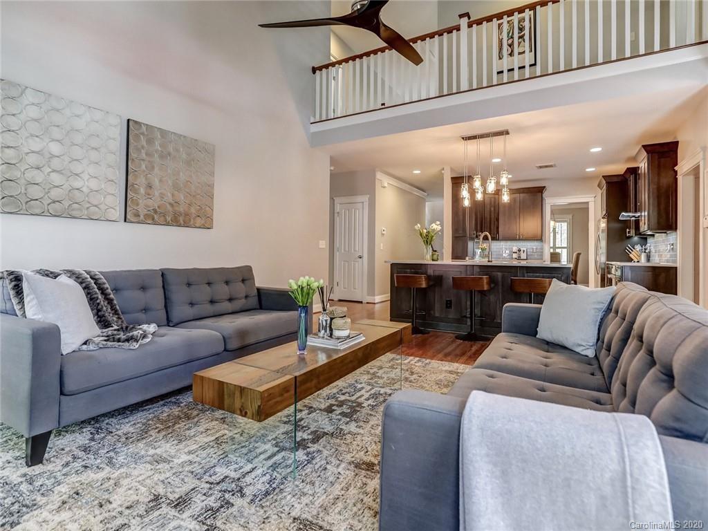 3384 Richard's Crossing Fort Mill, SC 29708 - Photo 22 of 48 a living room with furniture a kitchen view and a chandelier