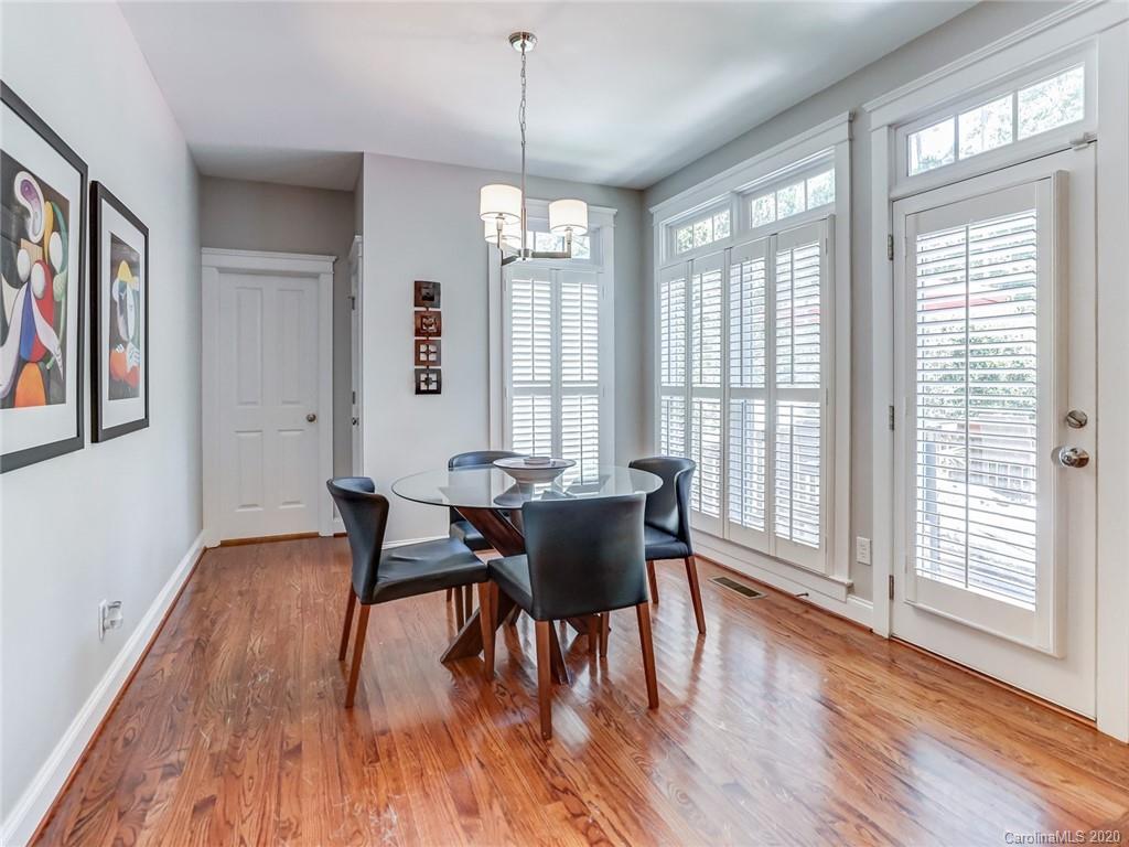 3384 Richard's Crossing Fort Mill, SC 29708 - Photo 24 of 48 a dining room with wooden floor a chandelier a glass table and chairs