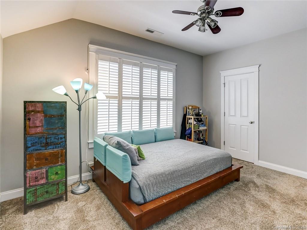 3384 Richard's Crossing Fort Mill, SC 29708 - Photo 33 of 48 a bedroom with a bed and a chandelier