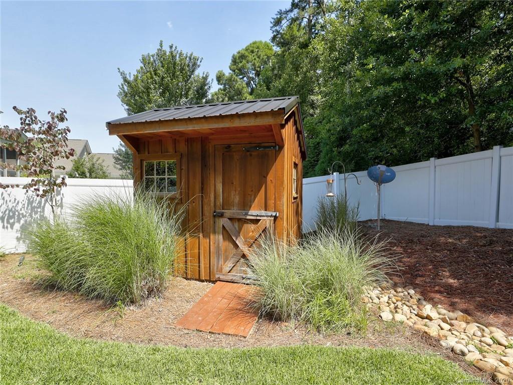 3384 Richard's Crossing Fort Mill, SC 29708 - Photo 47 of 48 a backyard of a house with plants and trees with wooden fence