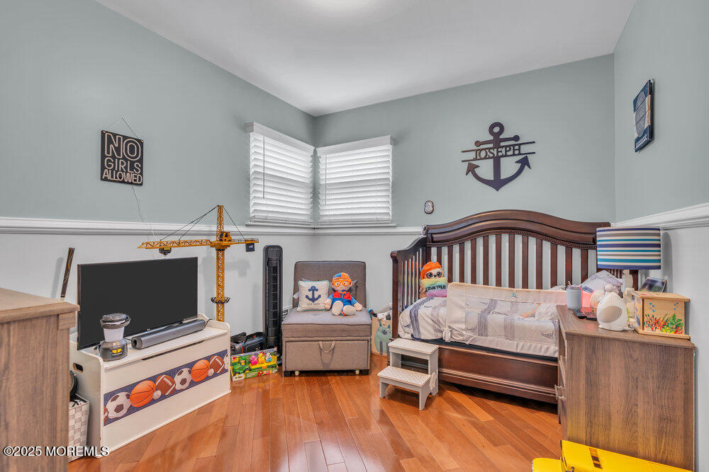 6 Coral Drive Hazlet, NJ 07730 - Photo 15 of 23 a bedroom with furniture and a flat screen tv