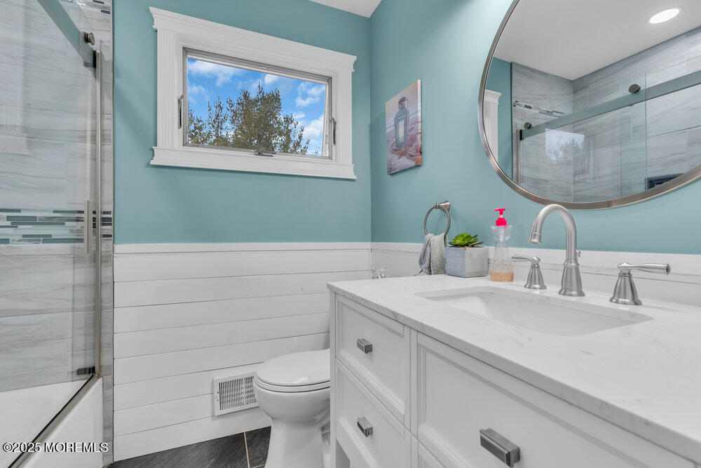 6 Coral Drive Hazlet, NJ 07730 - Photo 17 of 23 a bathroom with a sink a toilet and a mirror