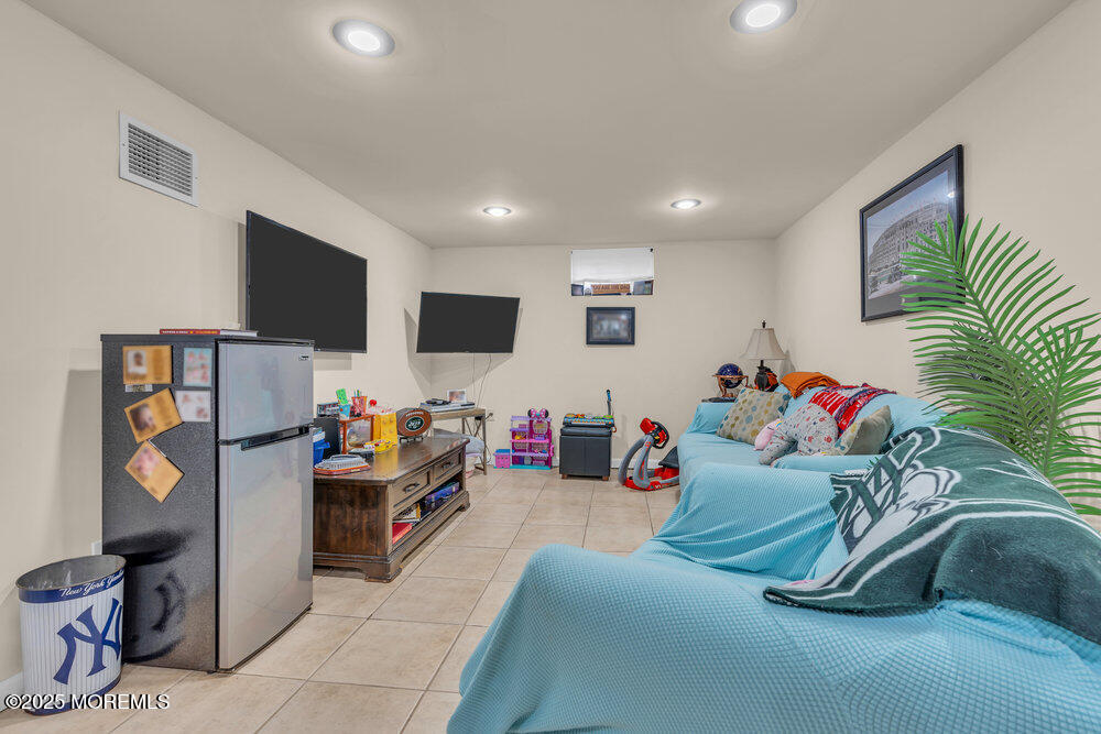 6 Coral Drive Hazlet, NJ 07730 - Photo 18 of 23 a bedroom with furniture and a flat screen tv