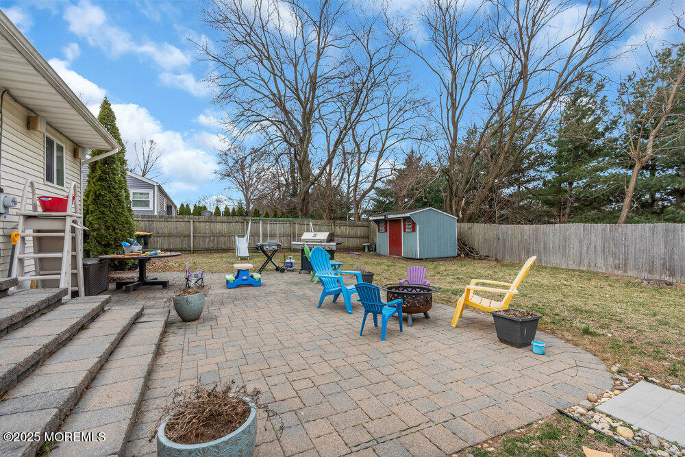 6 Coral Drive Hazlet, NJ 07730 - Photo 23 of 23 a backyard of a house with fire pit and outdoor seating