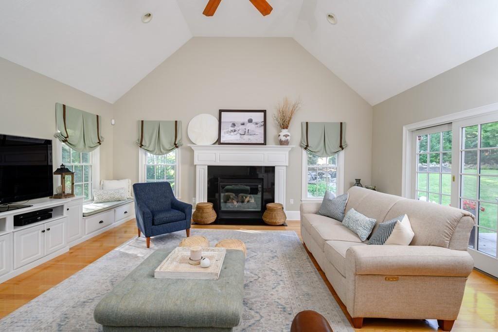 3 Lily Pond Lane Hingham, MA 02043 - Photo 13 of 42 a living room with furniture a flat screen tv and a fireplace
