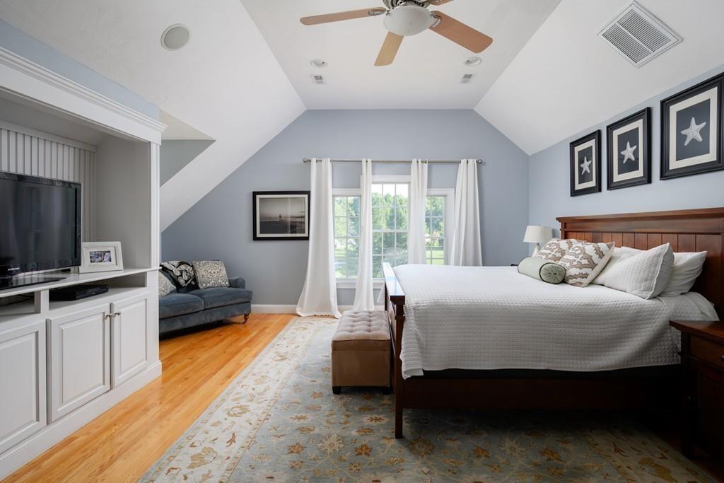 3 Lily Pond Lane Hingham, MA 02043 - Photo 22 of 42 a bedroom with a bed and wooden floor