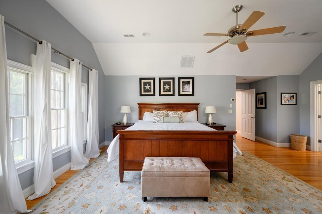 3 Lily Pond Lane Hingham, MA 02043 - Photo 24 of 42 a bedroom with a bed and a chandelier