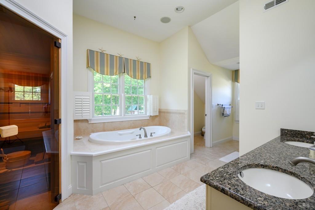 3 Lily Pond Lane Hingham, MA 02043 - Photo 25 of 42 a bathroom with a granite countertop tub sink a mirror and a shower