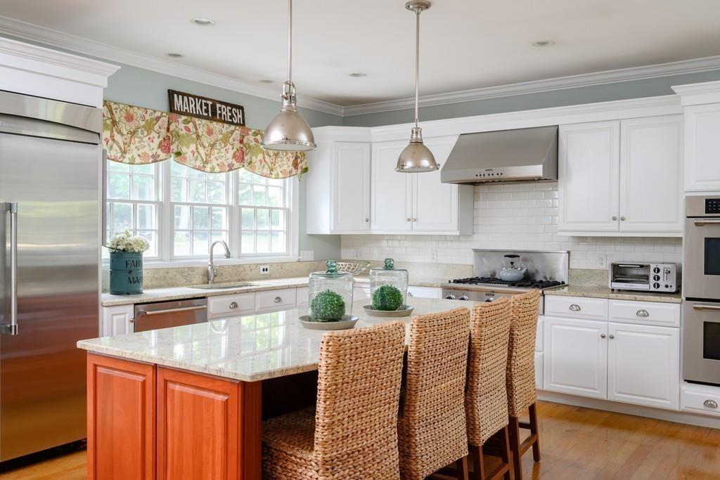 3 Lily Pond Lane Hingham, MA 02043 - Photo 3 of 42 a kitchen with stainless steel appliances granite countertop a stove a sink and white cabinets with wooden floor