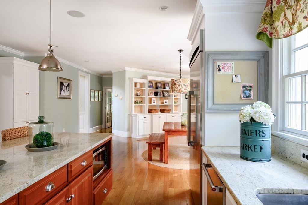 3 Lily Pond Lane Hingham, MA 02043 - Photo 6 of 42 a hallway with a dining table wooden floor and a chandelier