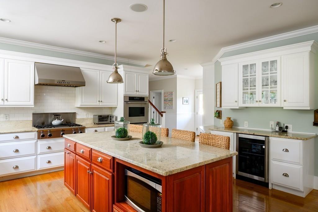 3 Lily Pond Lane Hingham, MA 02043 - Photo 7 of 42 a kitchen with stainless steel appliances granite countertop a sink a stove and a wooden floor