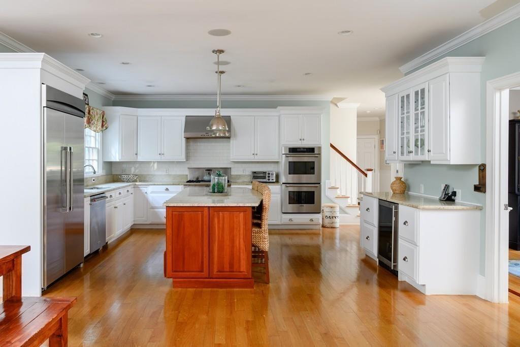 3 Lily Pond Lane Hingham, MA 02043 - Photo 9 of 42 a kitchen with stainless steel appliances granite countertop a refrigerator a stove top oven a sink dishwasher and white cabinets with wooden floor